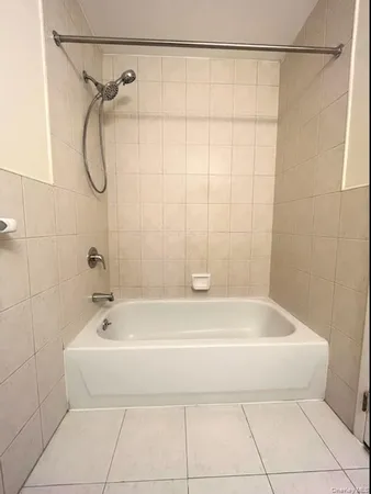 a bathroom with a bath tub with a shower