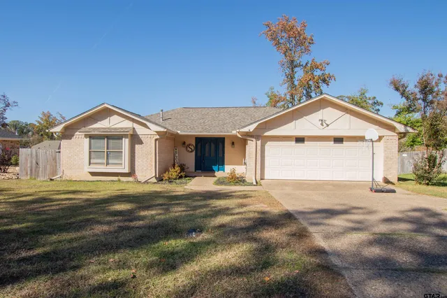 a view of a house with a yard and garage