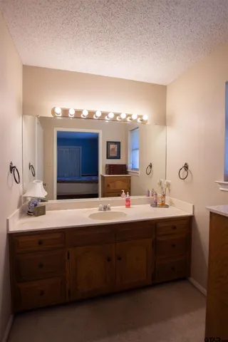 a bathroom with a double vanity sink and a mirror