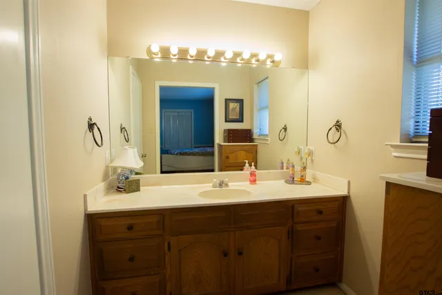 a bathroom with a double vanity sink and a mirror