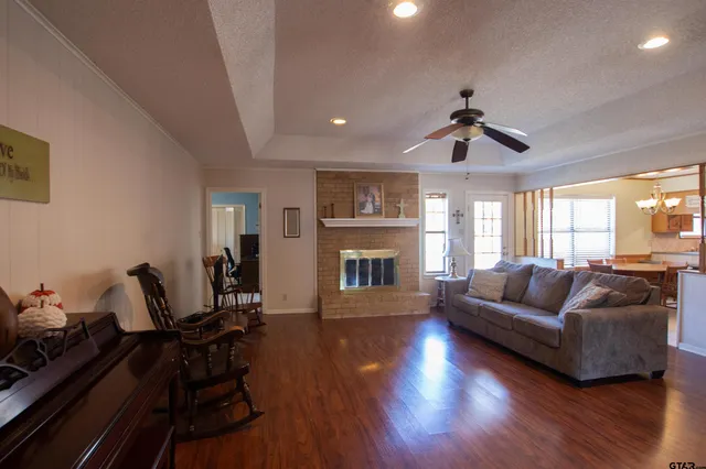 a living room with furniture fireplace and a window
