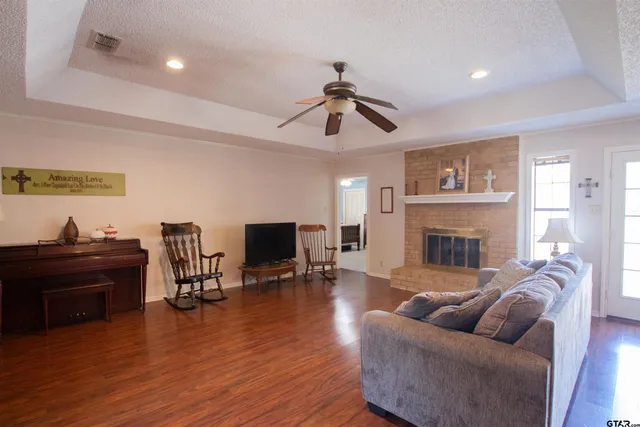 a living room with furniture fireplace and flat screen tv