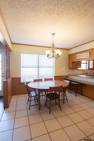 a view of a dining room with furniture and window