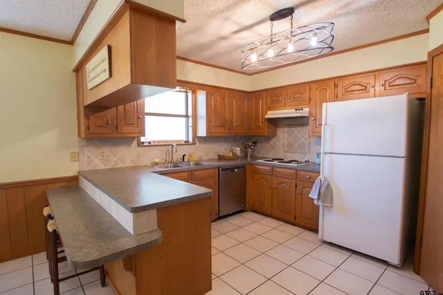 a kitchen with a sink appliances and cabinets