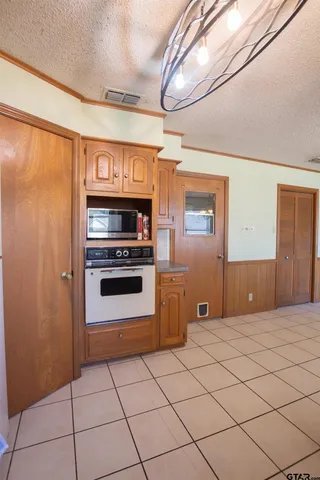 a kitchen with granite countertop a stove and a refrigerator