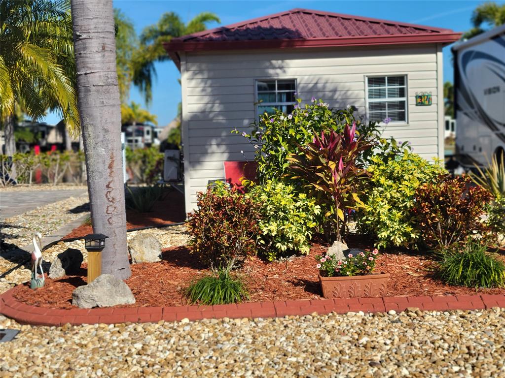 a view of a house with a yard and potted plants