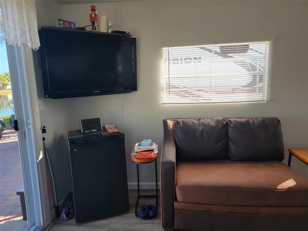 551 Southwest 42nd Cove Okeechobee, FL 34974 - Photo 19 of 25 a living room with furniture and a flat screen tv