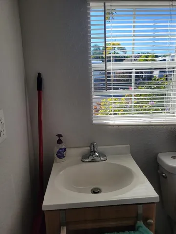a bathroom with a sink and a window