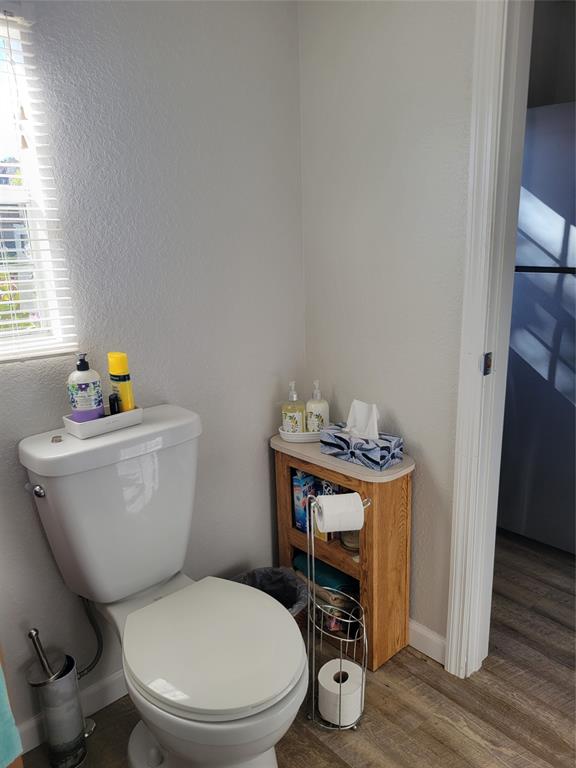 551 Southwest 42nd Cove Okeechobee, FL 34974 - Photo 24 of 25 a white toilet sitting next to a bathroom sink and vanity