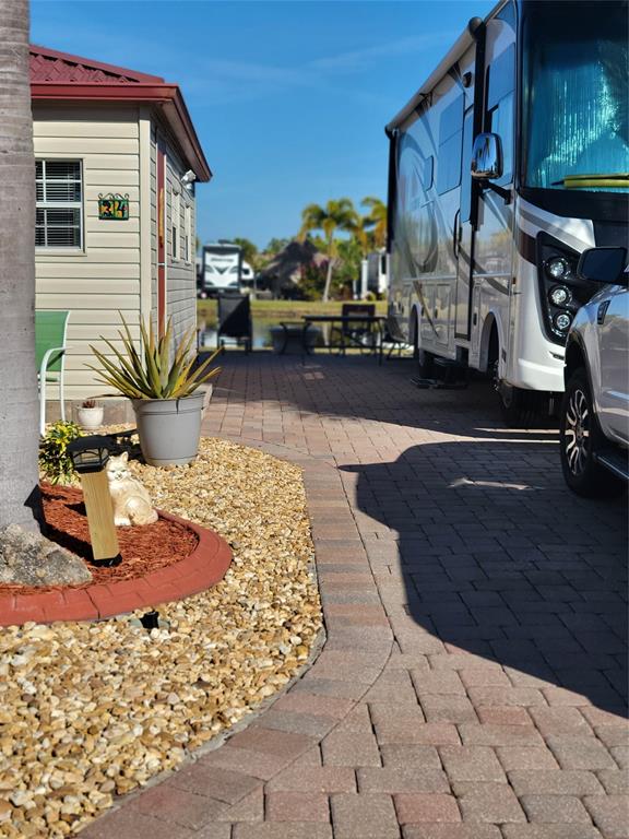 551 Southwest 42nd Cove Okeechobee, FL 34974 - Photo 5 of 25 a view of a patio with table and chairs potted plants