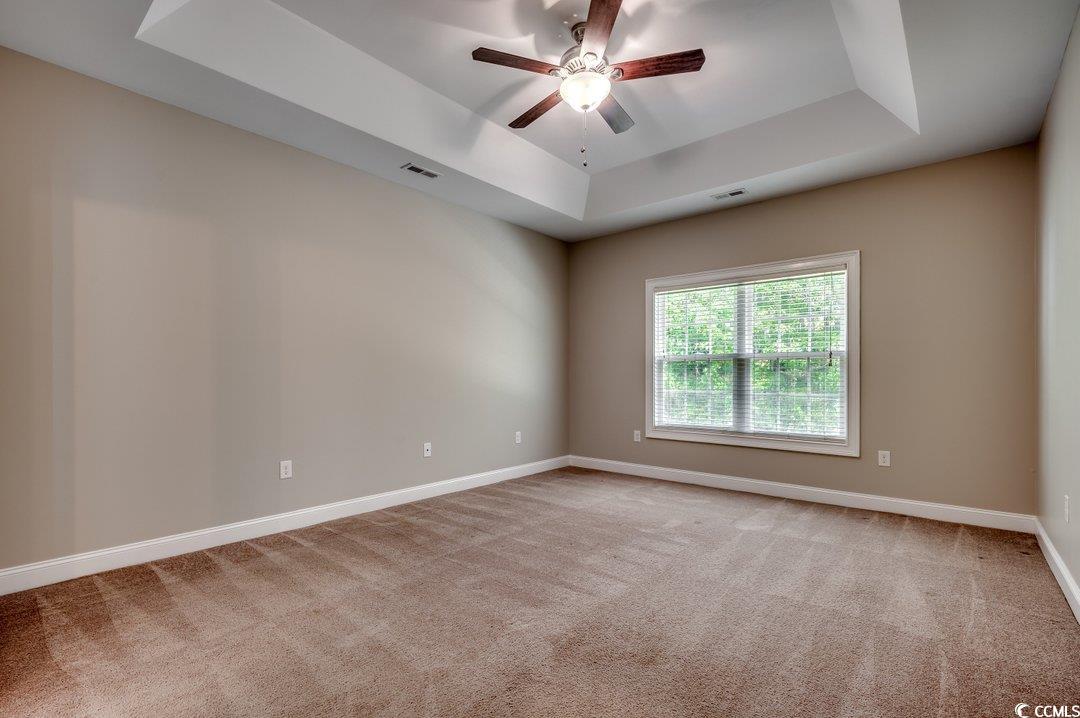 4076 Ridgewood Drive Conway, SC 29526 - Photo 17 of 32 Empty room featuring a raised ceiling, ceiling fan