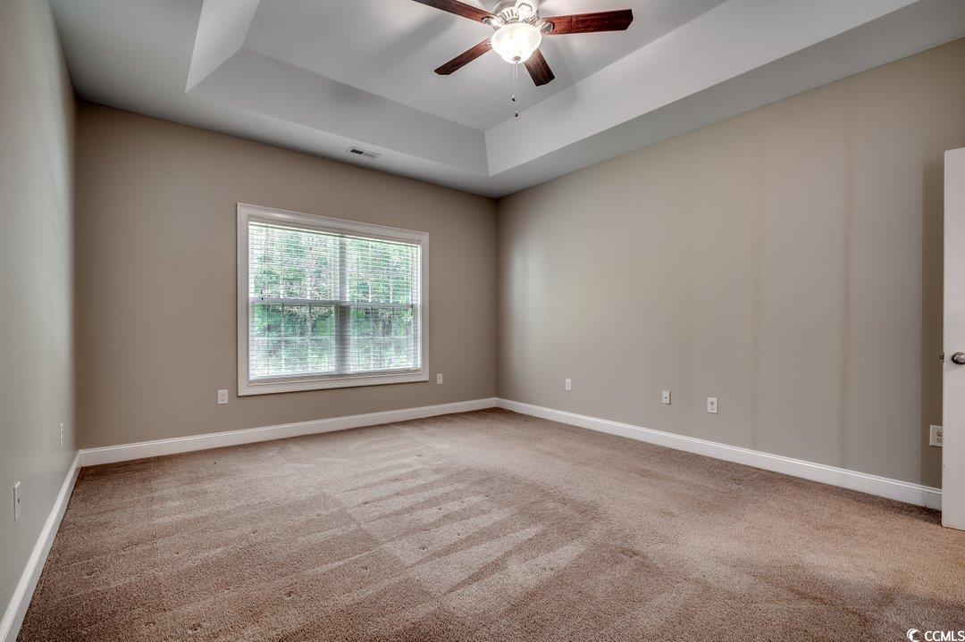 4076 Ridgewood Drive Conway, SC 29526 - Photo 18 of 32 Spare room featuring a tray ceiling, ceiling fan,