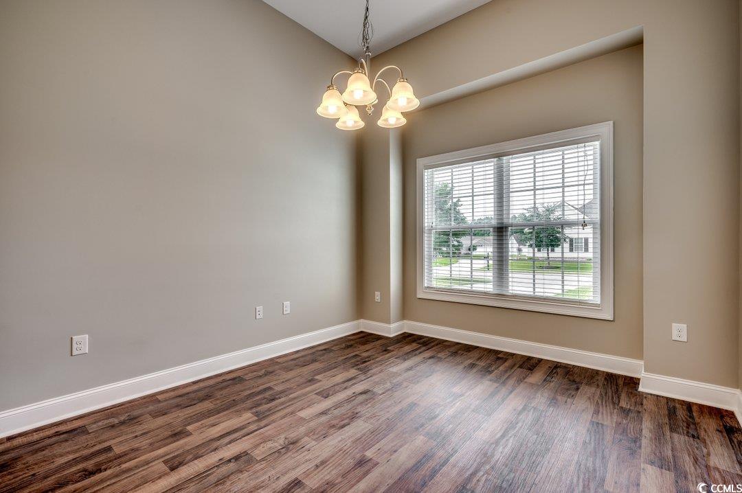 4076 Ridgewood Drive Conway, SC 29526 - Photo 3 of 32 Spare room with a notable chandelier and dark hard