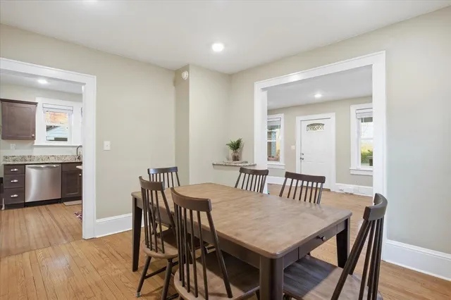 a view of a dining room with furniture and wooden floor