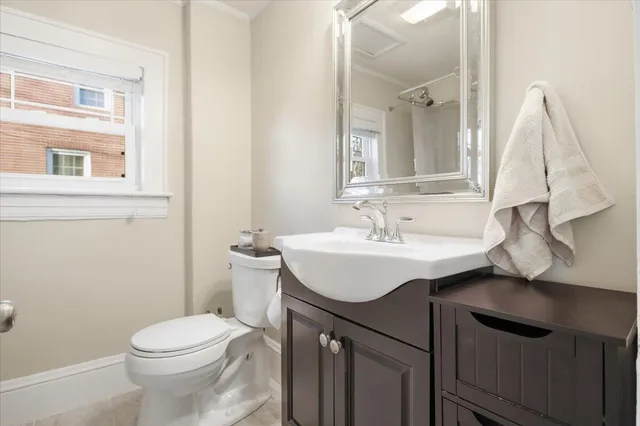 a bathroom with a sink toilet and a mirror