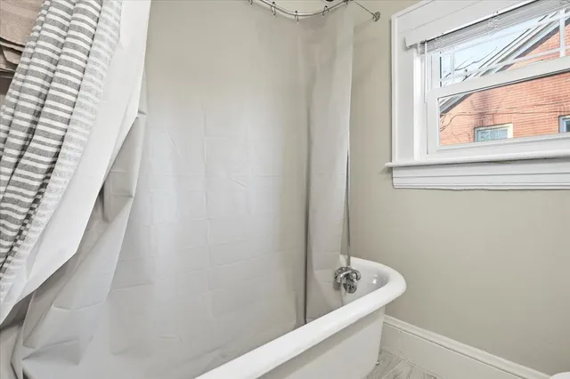 a bathroom with a tub and a window