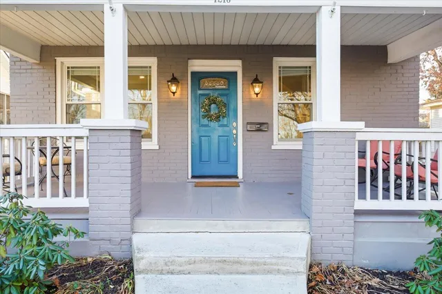 a view of front door of house with potted plant