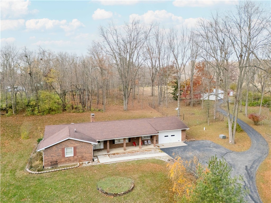 18333 Lefevre Number 2 Road Sidney, OH 45365 - Photo 13 of 25 This charming residence offers a secluded retreat with a serene woodland backdrop.