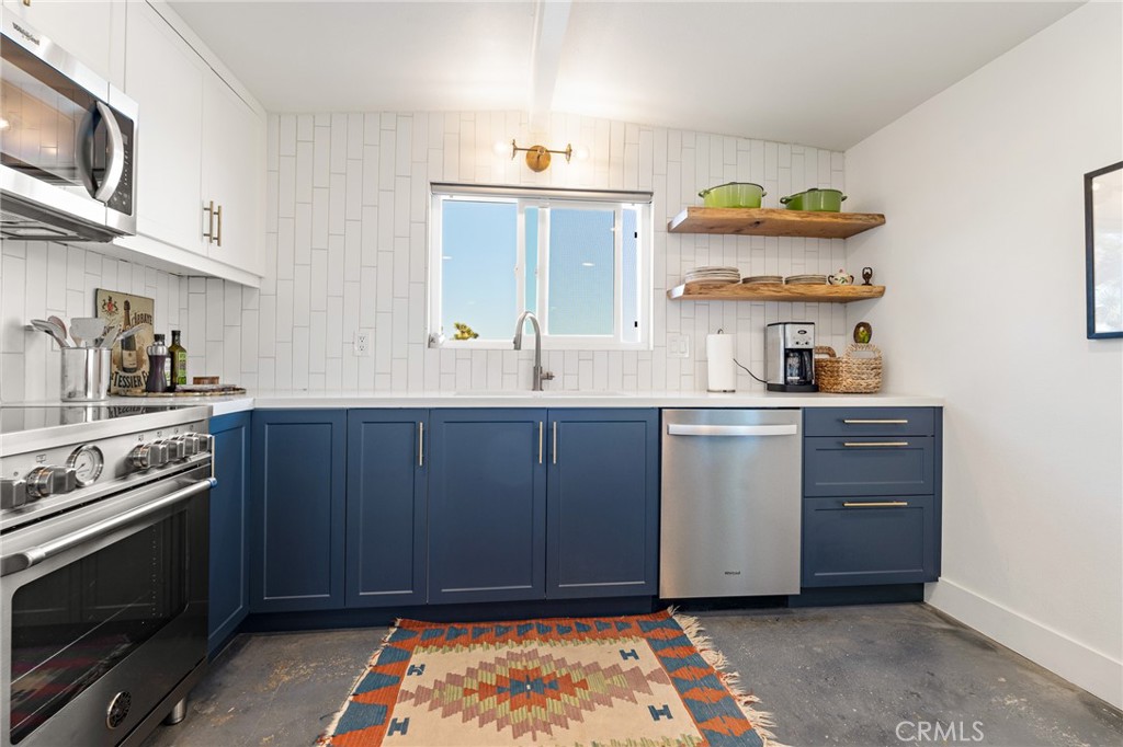4212 Oneill Road Joshua Tree, CA 92252 - Photo 13 of 60 a kitchen with a stove and cabinets