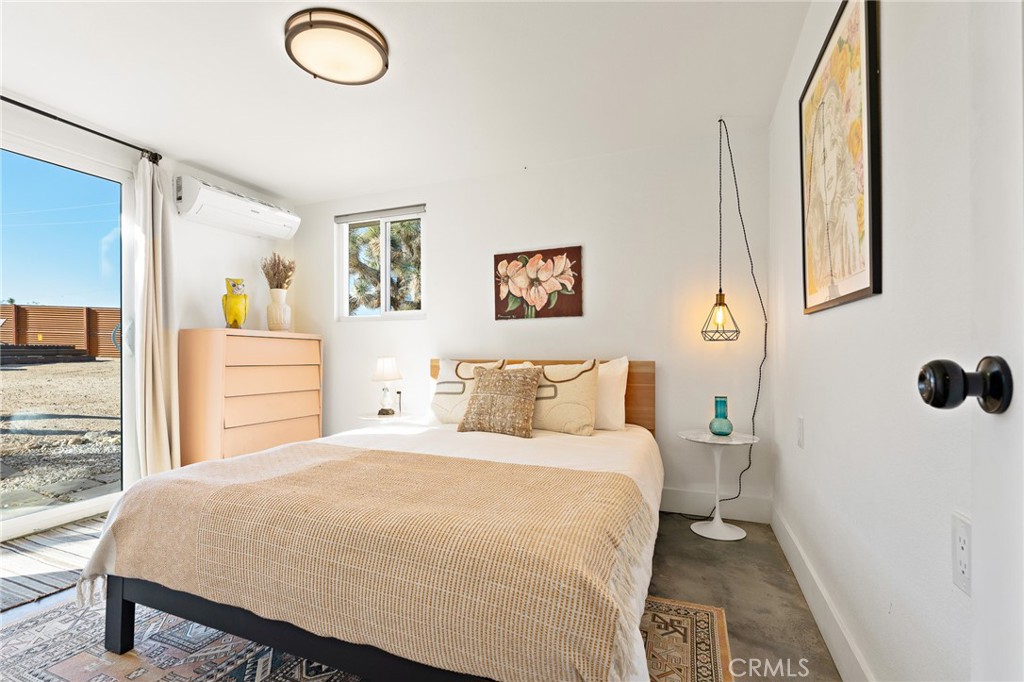 4212 Oneill Road Joshua Tree, CA 92252 - Photo 26 of 60 a bedroom with a bed and a window