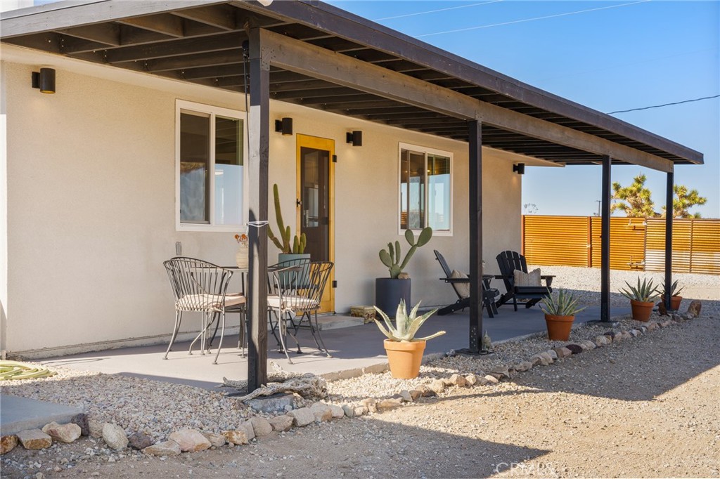 4212 Oneill Road Joshua Tree, CA 92252 - Photo 39 of 60 a view of a patio with a table and chairs