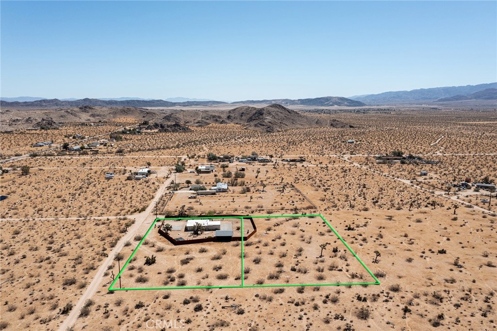 4212 Oneill Road Joshua Tree, CA 92252 - Photo 60 of 60 an aerial view of house with yard and mountain in the background