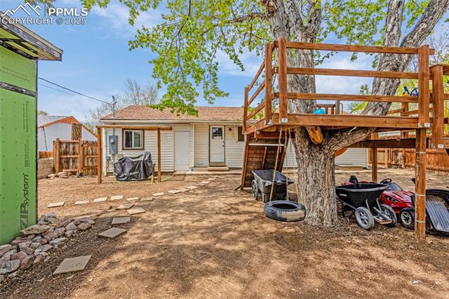 605 Huron Road Colorado Springs, CO 80910 - Photo 22 of 30 Back of property with fence and roof with shingles