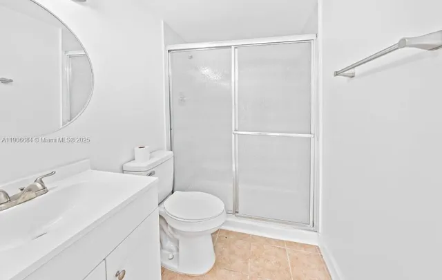 a bathroom with a toilet a sink and shower