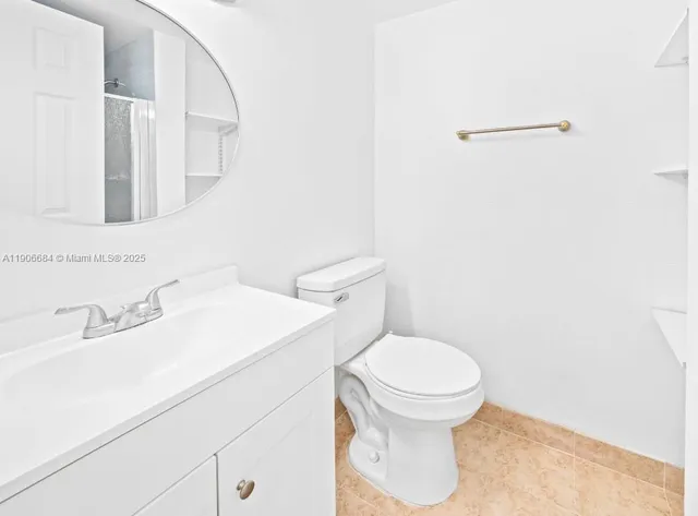 a bathroom with a sink a toilet and mirror