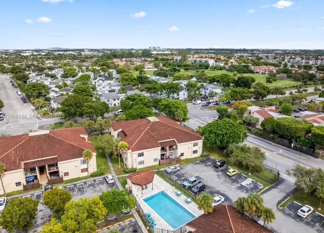 an aerial view of residential houses with outdoor space