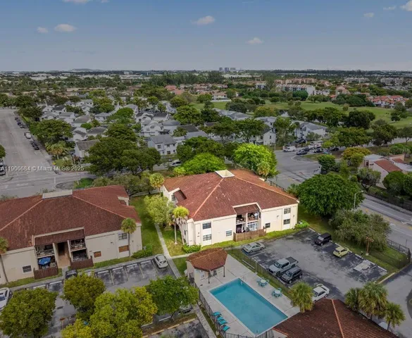an aerial view of multiple houses with a lake view