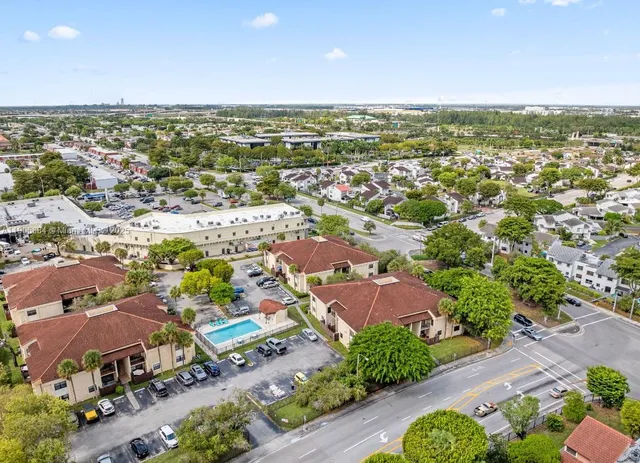 an aerial view of residential houses with outdoor space