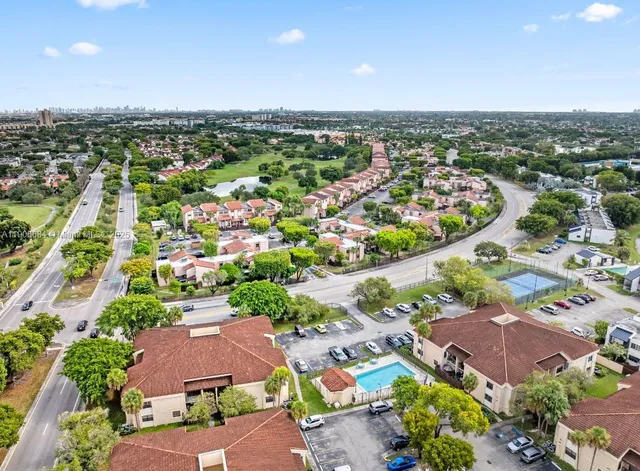 an aerial view of residential houses with outdoor space