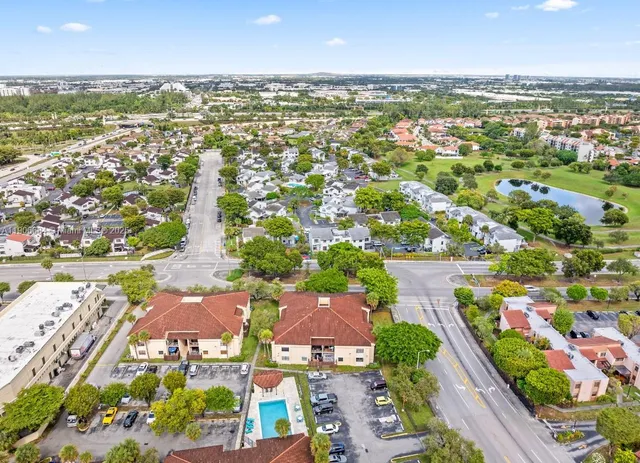 an aerial view of residential houses with outdoor space