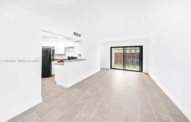 a view of a kitchen with a sink and a window