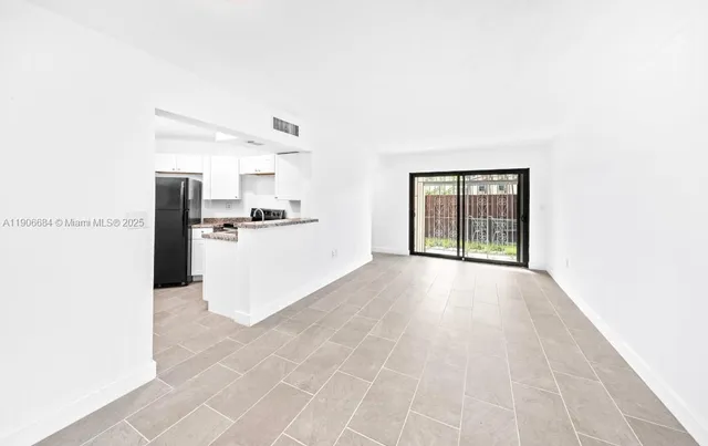 a view of a kitchen with a sink and a window