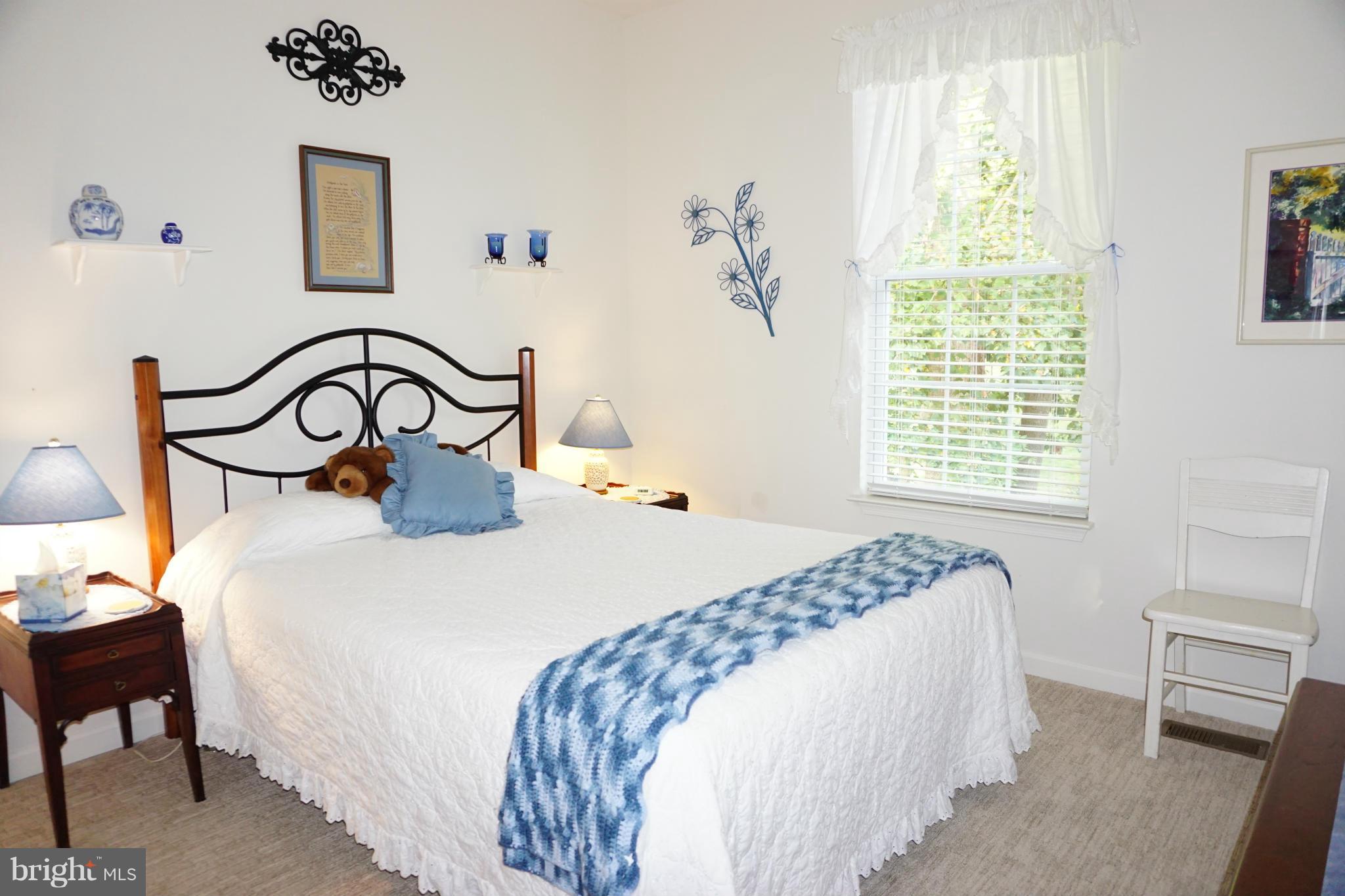 11202 Rawhide Road Lusby, MD 20657 - Photo 13 of 24 a bedroom with a bed and a table with window