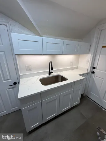 a kitchen with sink and cabinets