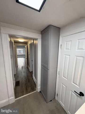 hallway with wooden floor and stairs