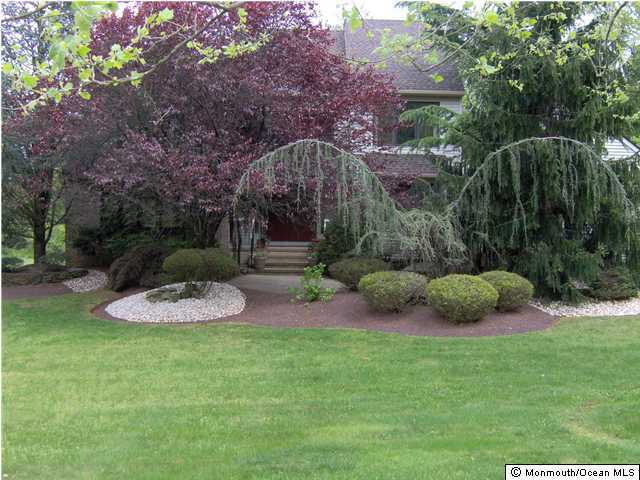 120 Hunt Road Freehold, NJ 07728 - Photo 1 of 3 a view of a backyard with plants and outdoor seating