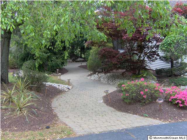 120 Hunt Road Freehold, NJ 07728 - Photo 2 of 3 a view of a garden with flowers and trees