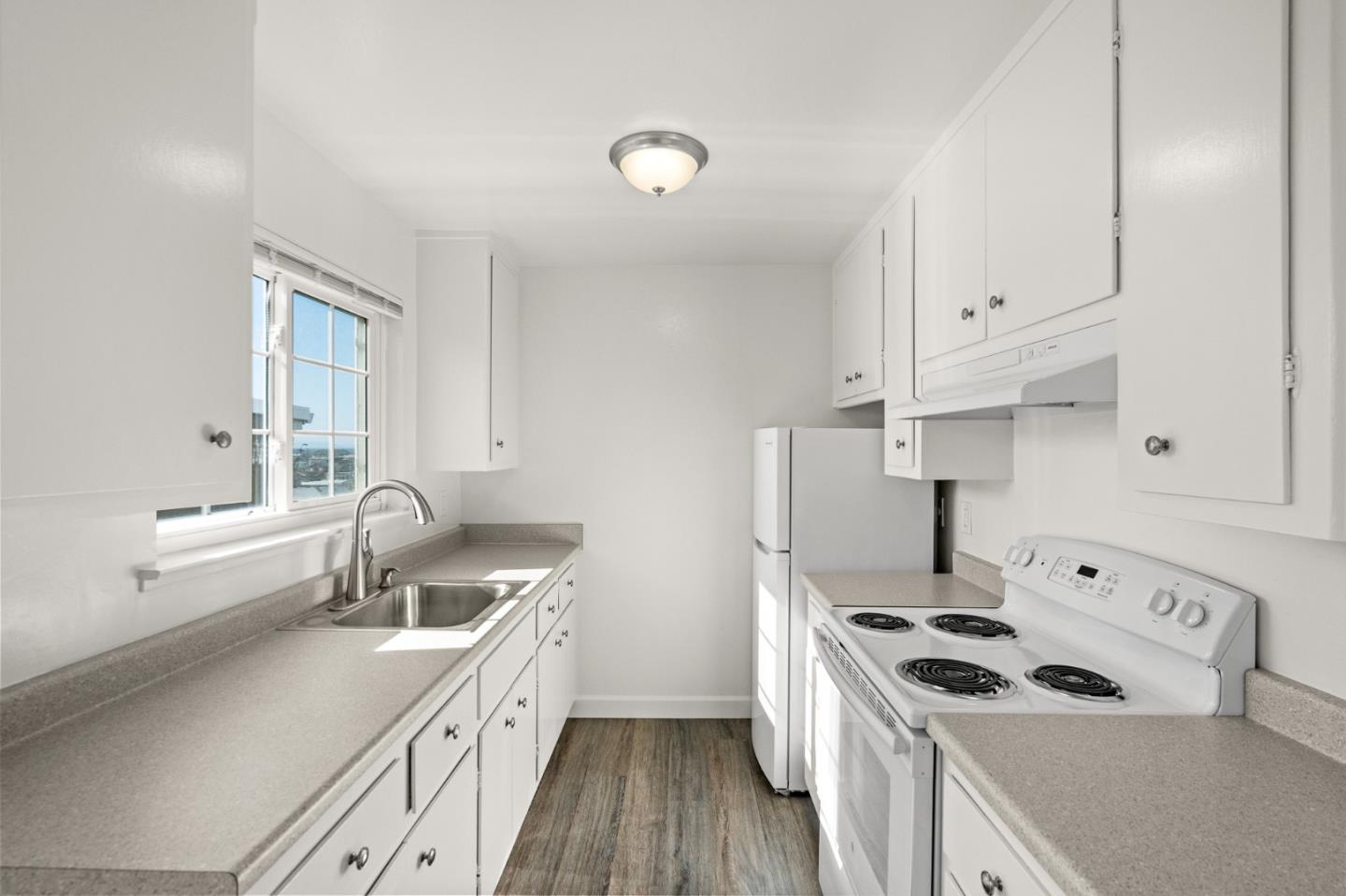 127 Hilton Way Pacifica, CA 94044 - Photo 13 of 18 a kitchen that has a sink a stove and window