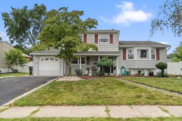 a view of a house with a yard and sitting area