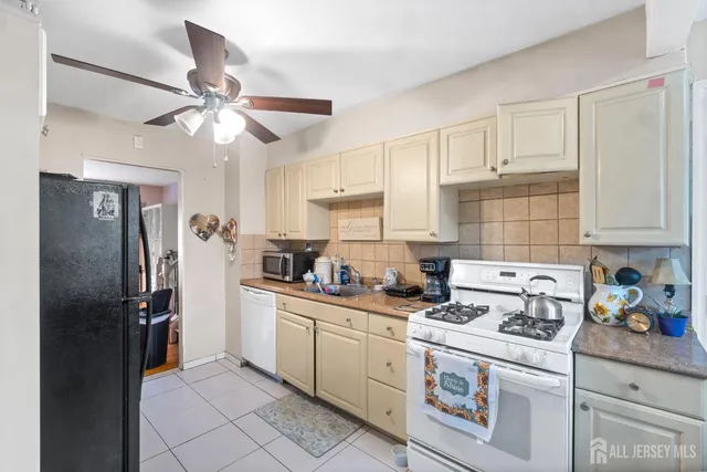 a kitchen with stainless steel appliances a refrigerator sink and cabinets
