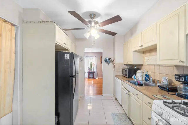 a kitchen with a refrigerator a sink and cabinets