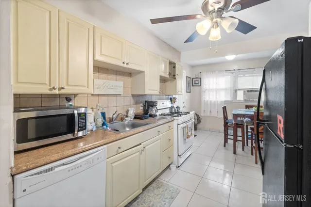 a kitchen with a stove cabinets and microwave