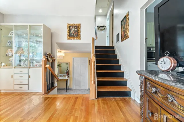 a view of a hallway with entryway wooden floor and front door