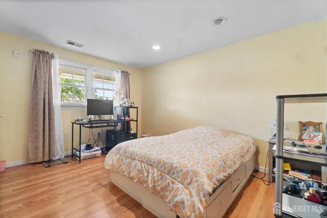 a spacious bedroom with a bed and a table in it