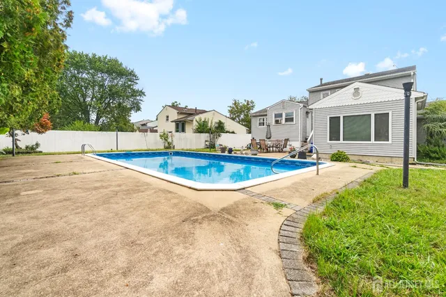 a view of swimming pool with seating space