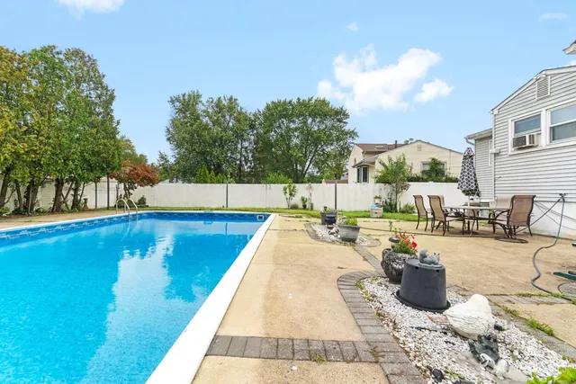 a view of a backyard with swimming pool